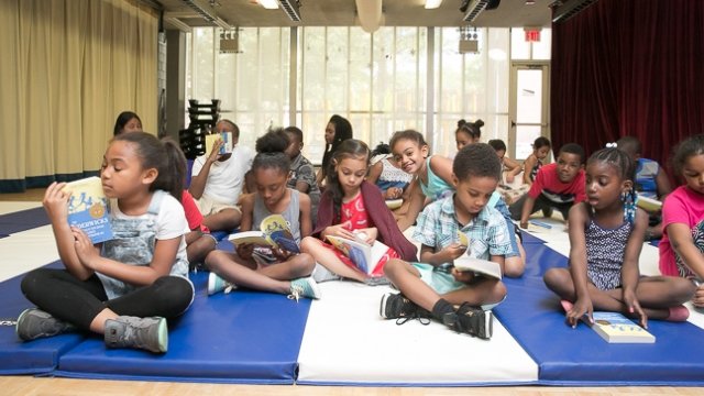 Children reading at the National Book Foundation's Book-Rich Environments Initiative launch.