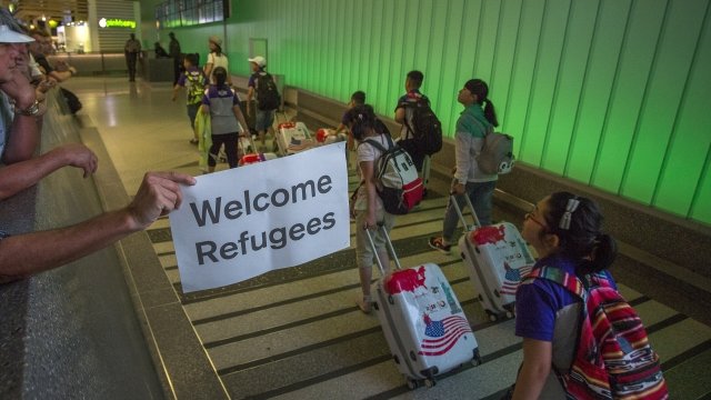 Americans welcome people at an airport.