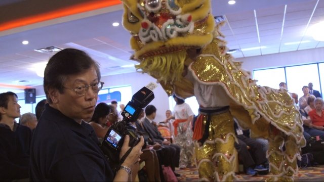 Photographer Corky Lee takes photographs at the 54th Chinese American Citizens Alliance National Convention.