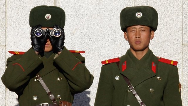 Two North Korean soldiers stand watch.