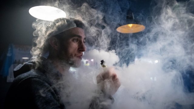 A man uses an e-cigarette