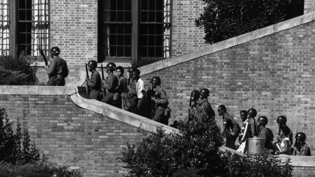 Troops escort the Little Rock Nine into Central High School in 1957