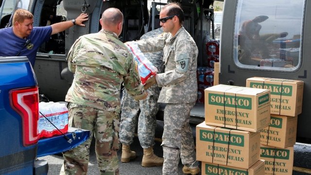 U.S. National Guardsmen carry supplies.