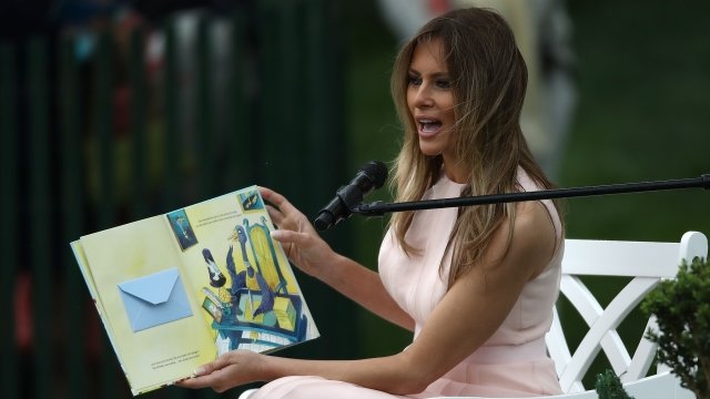 U.S. first lady Melania Trump reads to children from a book.