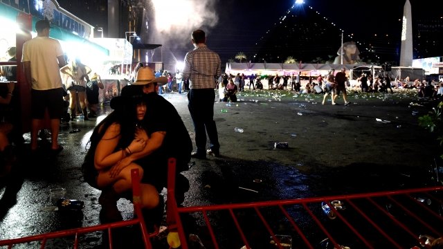 People take cover at the Route 91 Harvest country music festival after gunfire was heard.