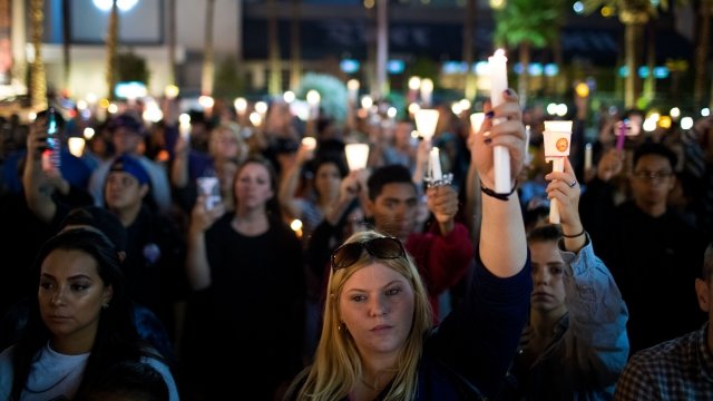 Mourners attend a candlelight vigil at the corner of Sahara Avenue and Las Vegas Boulevard.