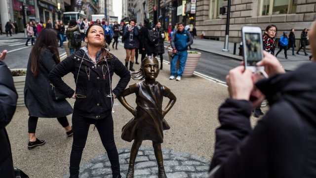 Woman by "Fearless Girl" statue in New York City