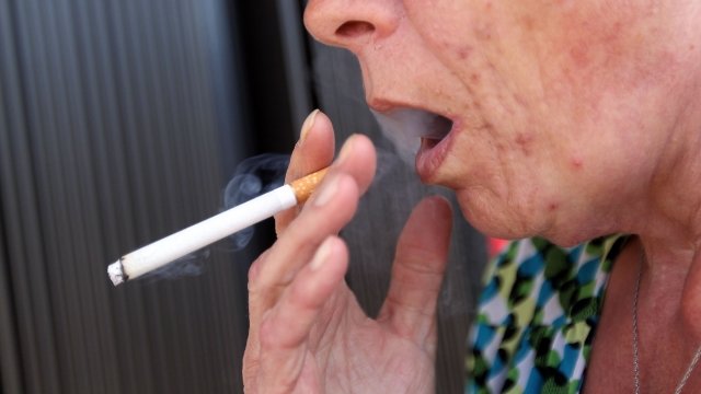 Woman smokes a menthol cigarette