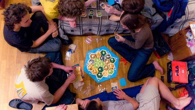 People playing Settlers of Catan