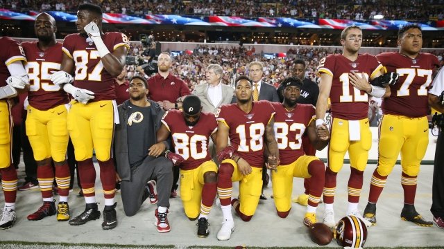 Washington Redskins players kneel during the anthem