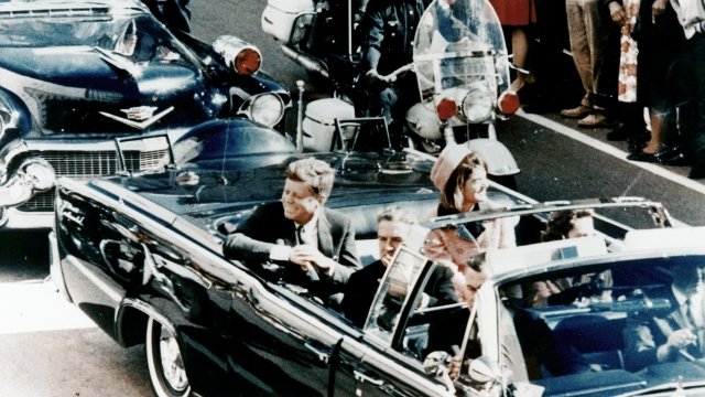 President John F. Kennedy travels in a motorcade on the day of his assassination