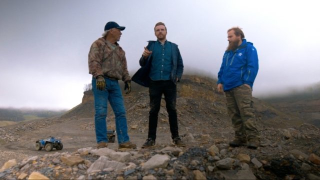 Retired miner Chuck Nelson, reporter Zach Toombs and mountaintop removal opponent Junior Walk overlook a coal waste site.