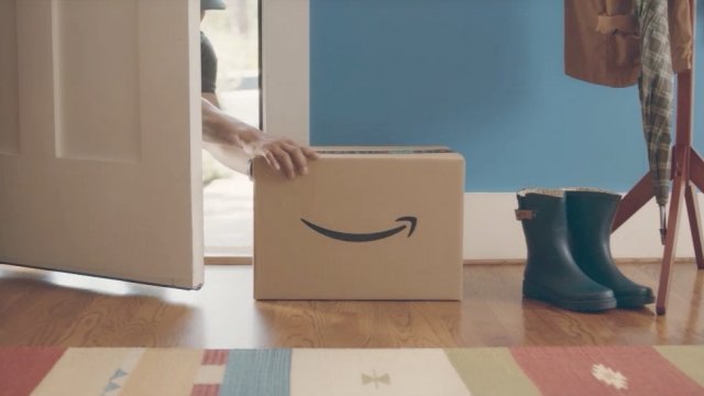 A person delivers an Amazon package inside a home