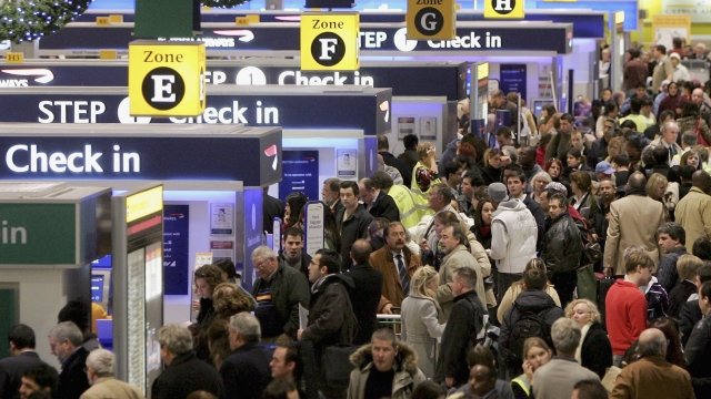 Passengers queue to check-in at terminal 1 of Heathrow Airport.