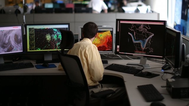 Meteorologist monitors weather in NOAA's Center for Weather and Climate Prediction.