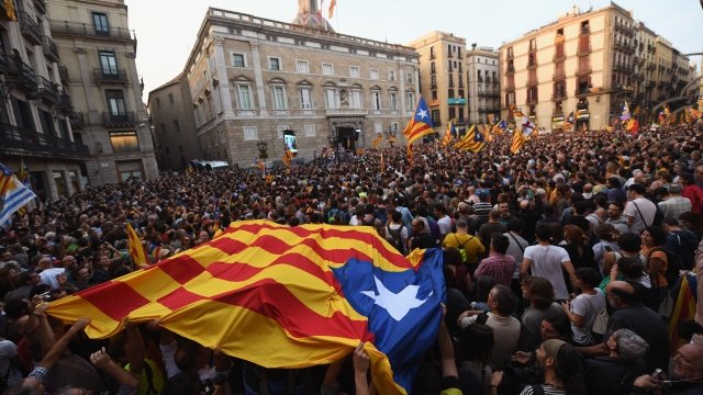 Catalans gather outside a government building