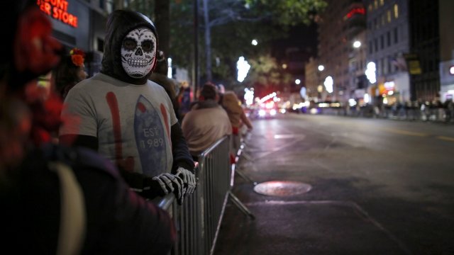 People attend an annual Halloween parade in New York City after a man driving a rental truck struck and killed eight people.