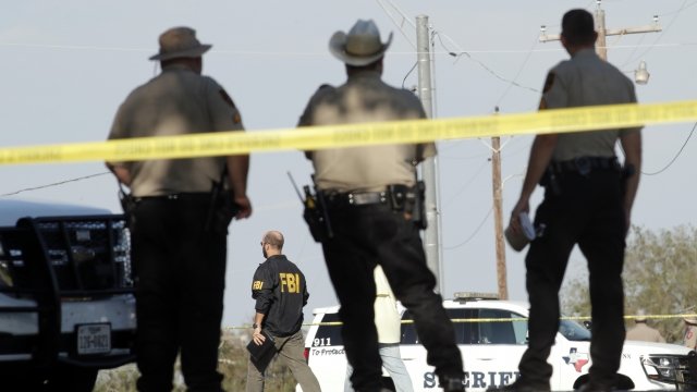 Law enforcement officials near the scene of the mass shooting in Sutherland Springs, Texas.