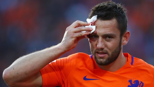 Stefan de Vrij of the Netherlands of the Netherlands Men's National Soccer Team holds gauze up to a wound on his forehead