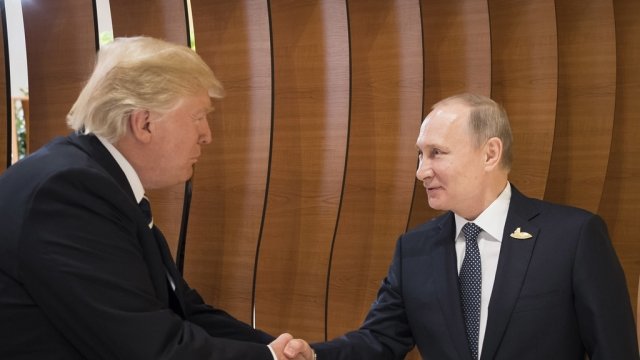 President Donald Trump shakes hands with President Vladimir Putin