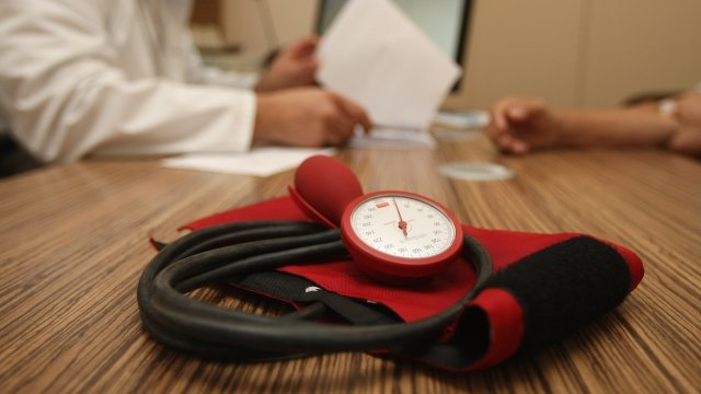 Blood pressure meter on table where doctor talks to patient