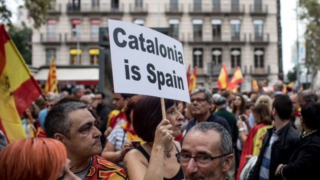 A woman hold and anti Catalonia independence sign