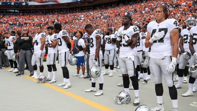 Oakland Raider stand during the national anthem