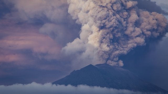 Mount Agung spews volcanic ash into the sky during an eruption.