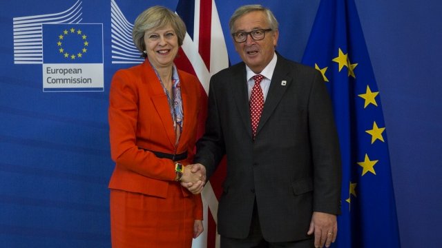 British Prime Minister Theresa May shakes hands with President of the European Commission Jean-Claude Juncker.