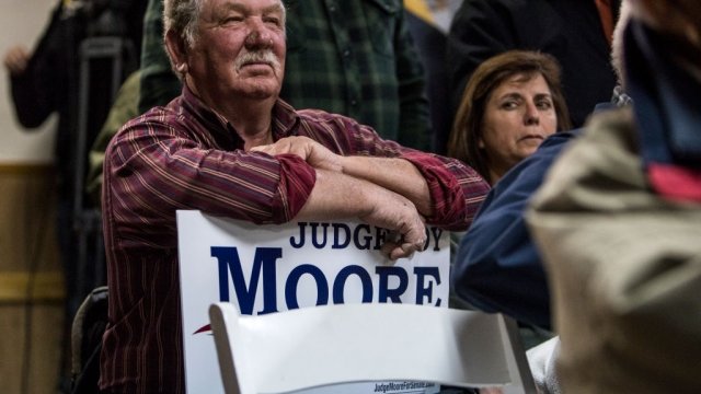 A supporter listens to Republican Senate candidate Roy Moore speak
