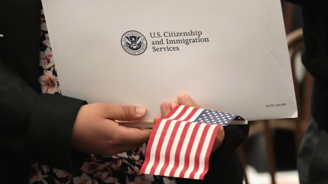 An immigrant holds a packet of information.