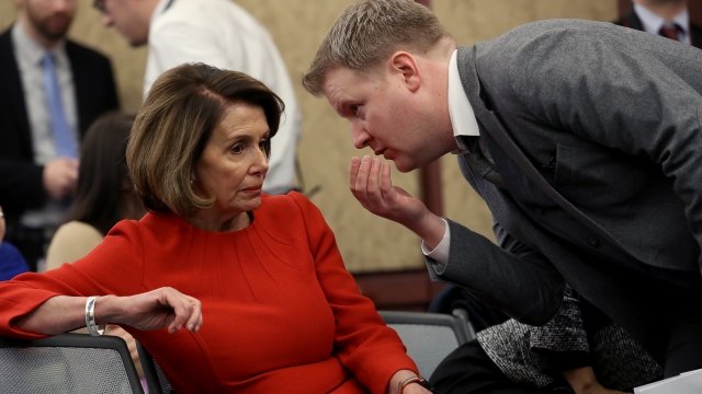 House Minority Leader Nancy Pelosi talks to a man