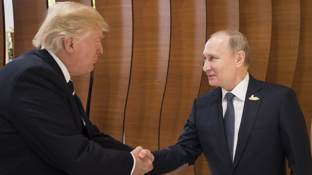 U.S. President Donald Trump shakes hands with Russian President Vladimir Putin
