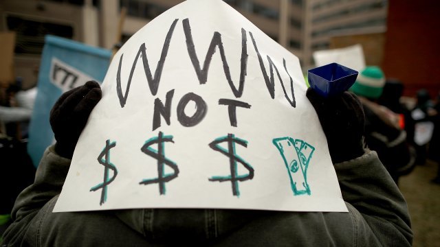Demonstrators rally outside the Federal Communication Commission building to protest the end of net neutrality rules