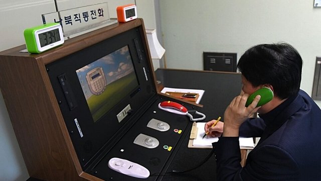 A South Korean government official communicates with a North Korean officer during a phone call.