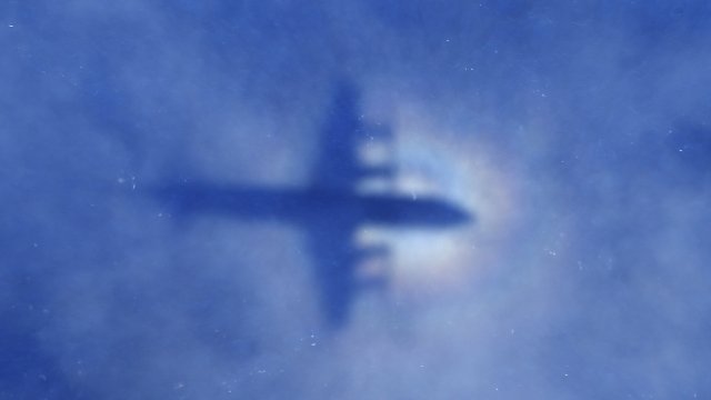 A plane searching for MH370 flies over the ocean