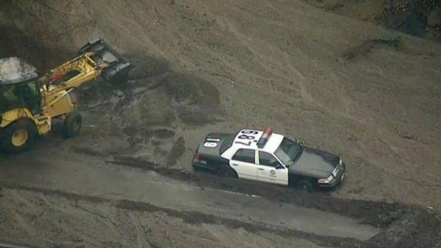 A police car trapped in mud