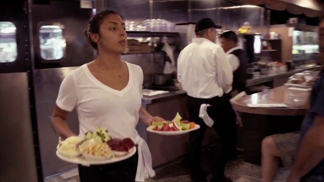 Restaurant worker serves meals.