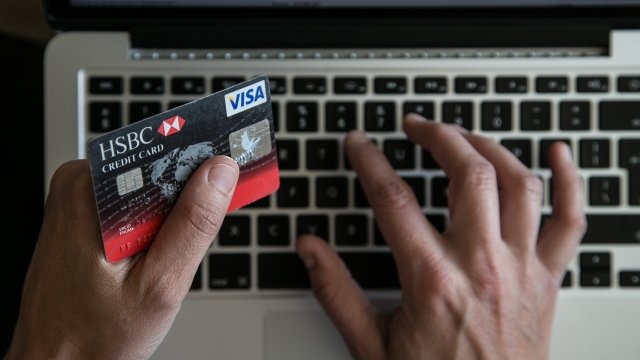 A person uses a credit card to buy something online.