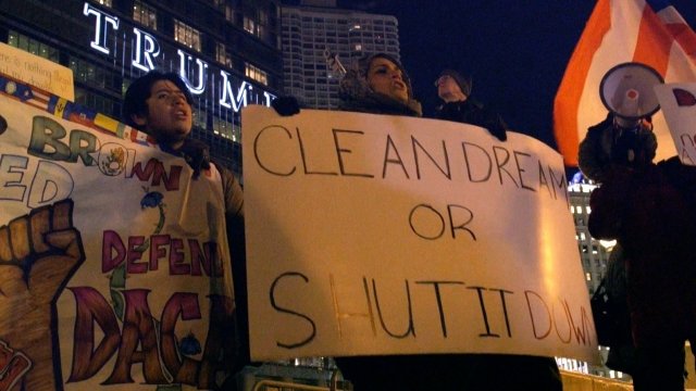 Protesters with a sign that reads "CLEAN DREAM OR SHUT IT DOWN" in front of the Trump Tower in Chicago.