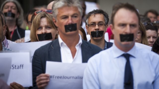 Journalists take part in a silent protest