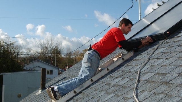 Andrew Koyaanisqatsi installs solar panels for a domestic hot water system in Oregon.