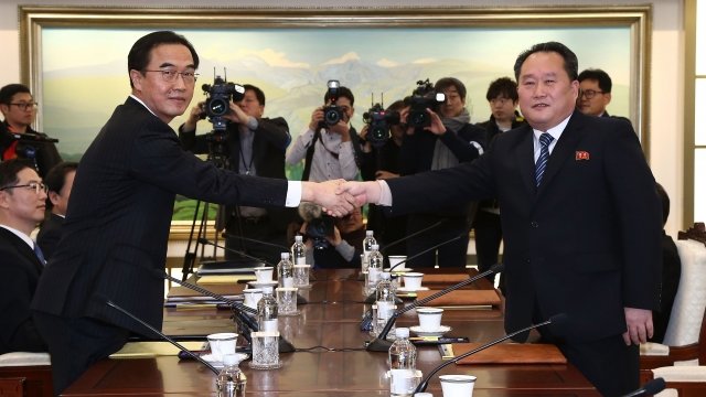 North and South Korean delegates shake hands