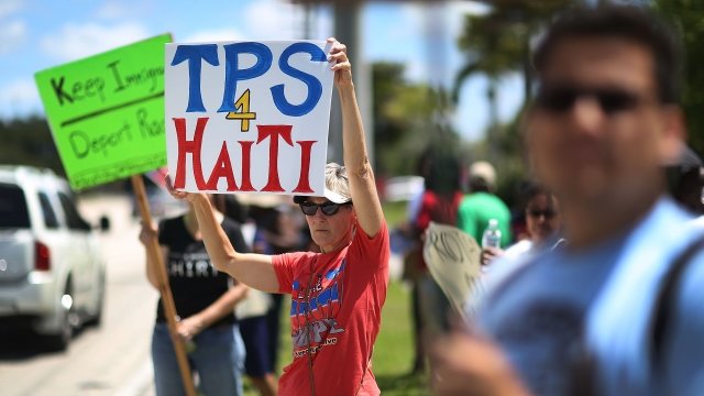 Person holds a TPS 4 Haiti sign at a protest