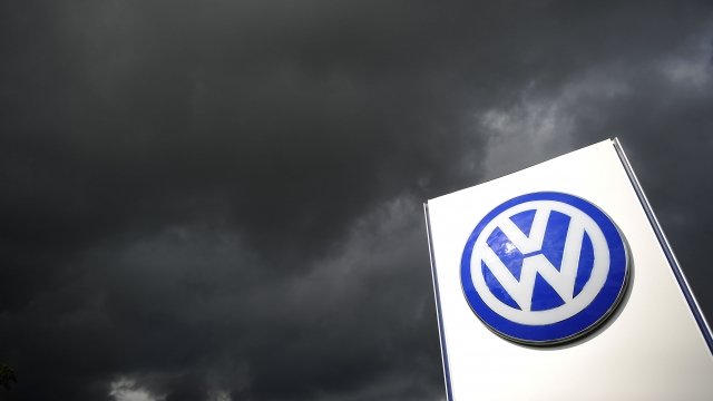 Rain clouds are seen over a Volkswagen symbol.