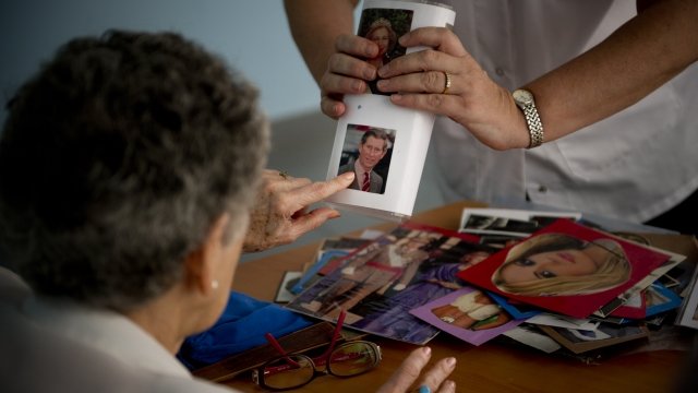 An elderly woman participates in a memory game activity