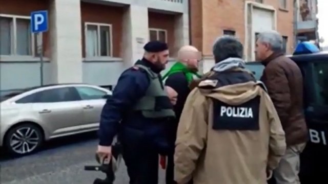 Italian police arresting man in relation to migrant shooting