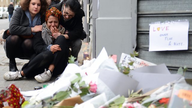 A woman cries near Le Petit Cambodge restaurant, the day after the deadly attack.