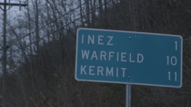 A sign that shows town names