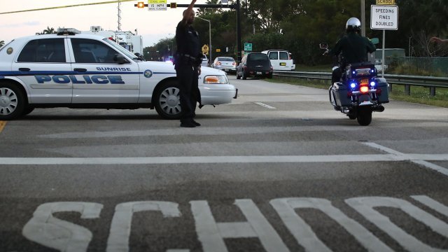 Police outside ​Marjory Stoneman Douglas High School in Florida